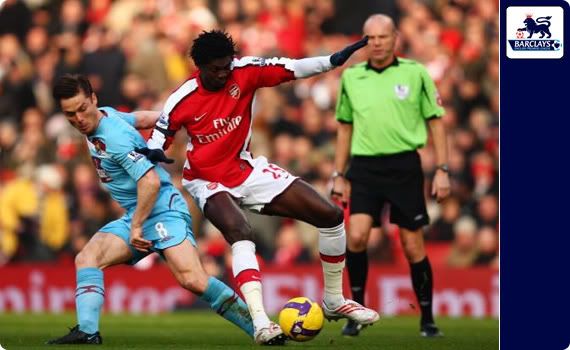 Scott Parker challenges Emmanuel Adebayor during the match between Arsenal and West Ham United