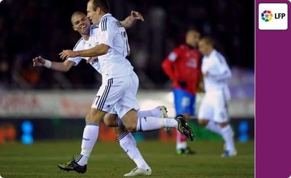Arjen Robben celebrates scoring his sides second goal with his teammate Pepe during the La Liga match between Numancia and Real Madrid